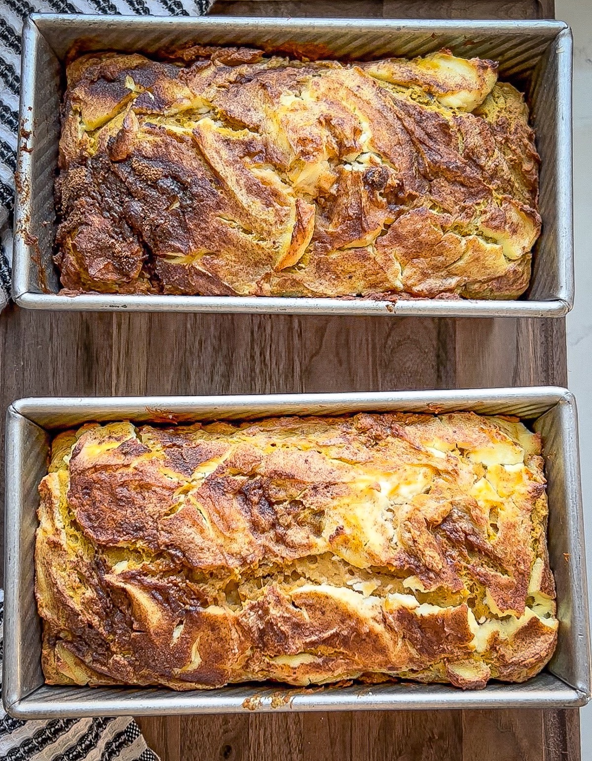 2 baked pumpkin loaves fresh from the oven, side-by-side
