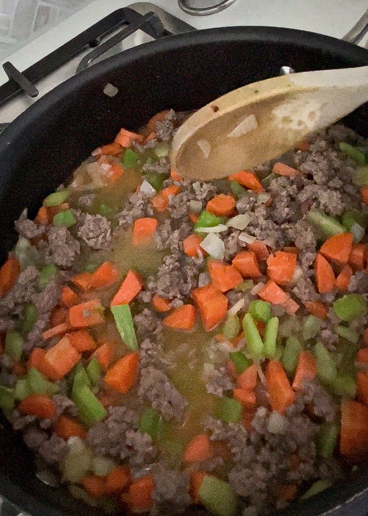 beef cooking with vegetables in a skillet