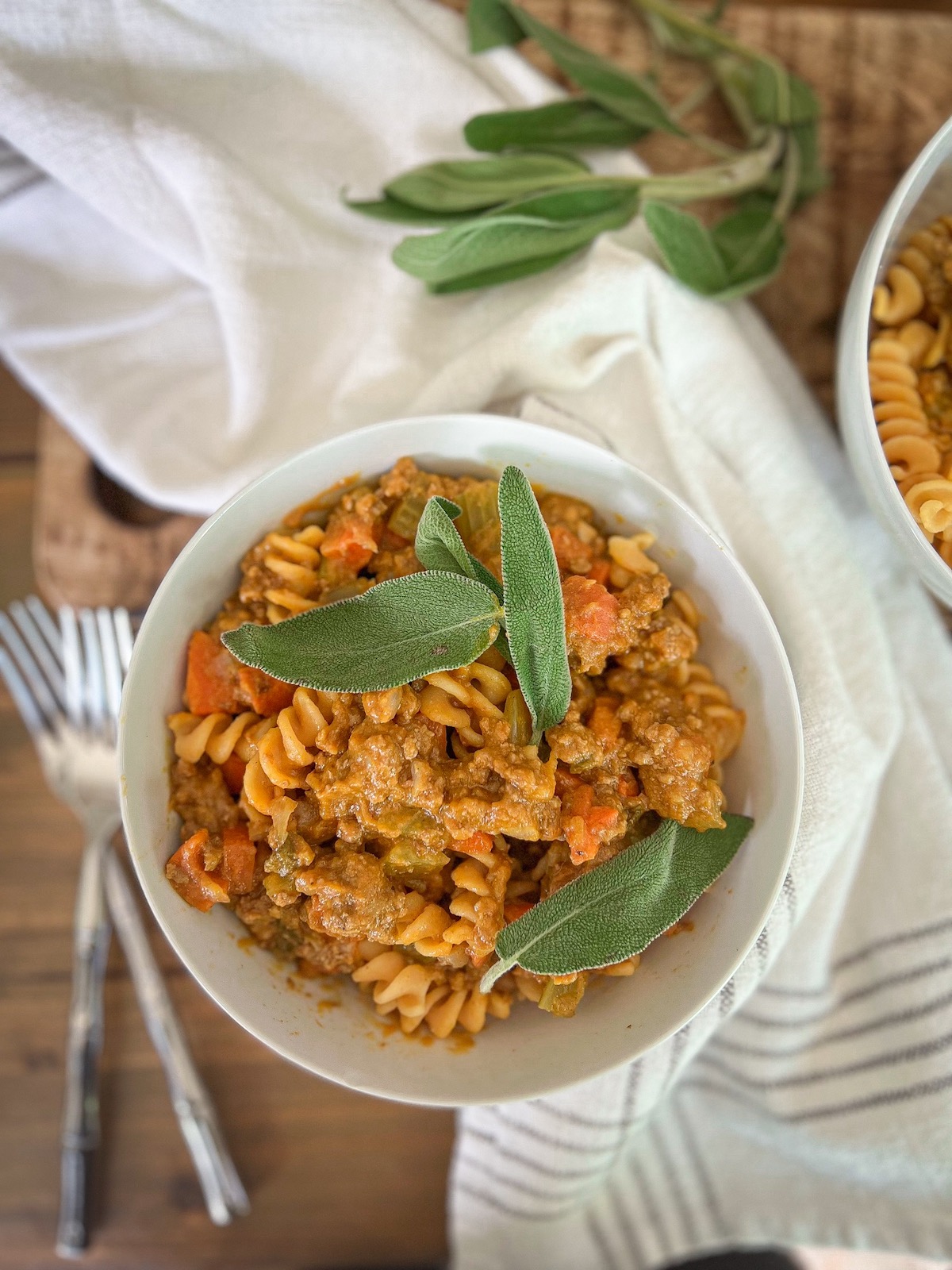 pumpkin bolognese in a bowl topped with sage leaves
