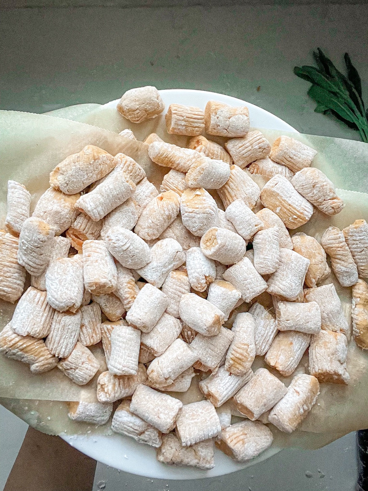 plate full of sweet potato gnocchi on parchment paper