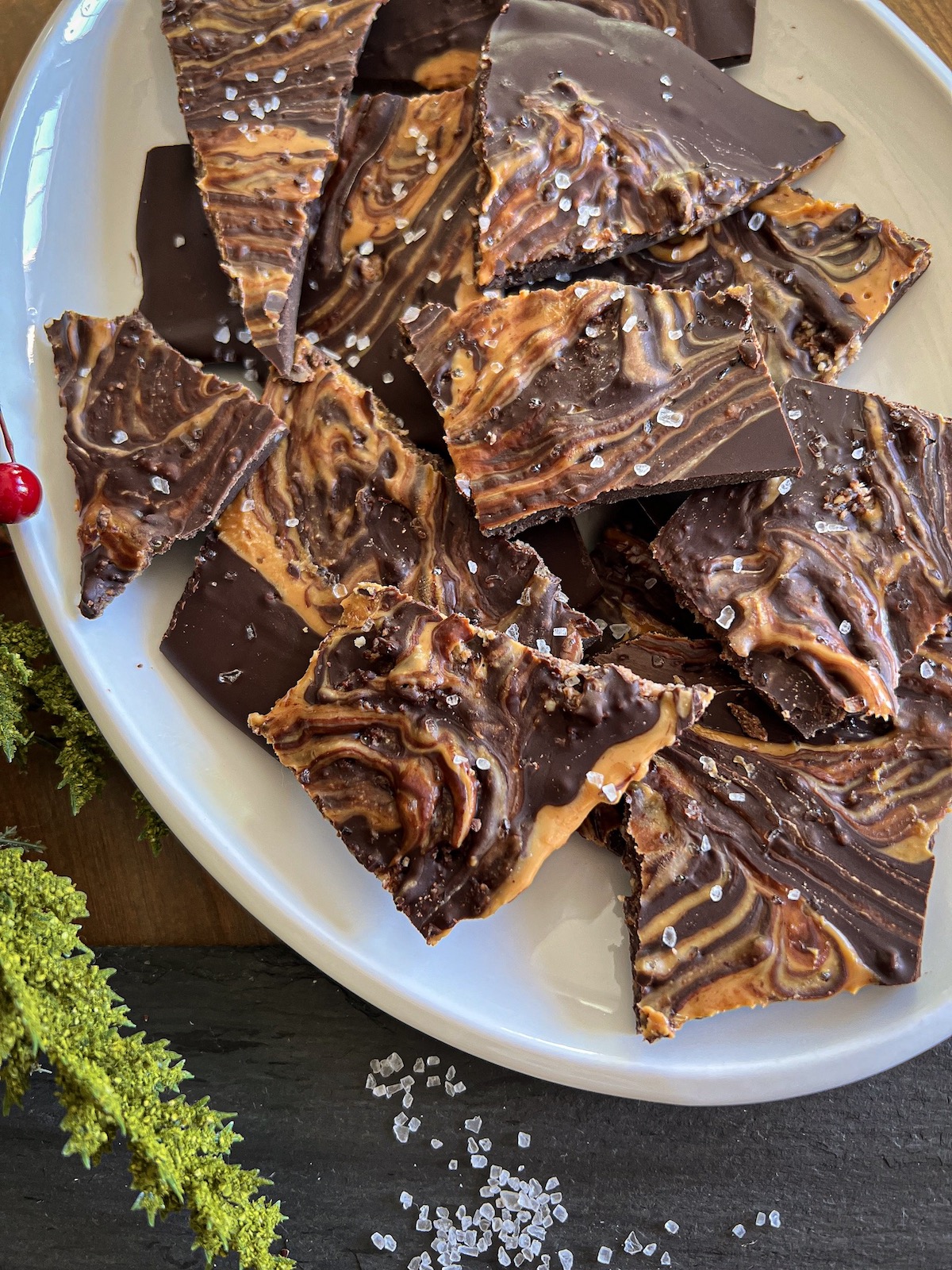 chocolate peanut butter bark on a white oval plate