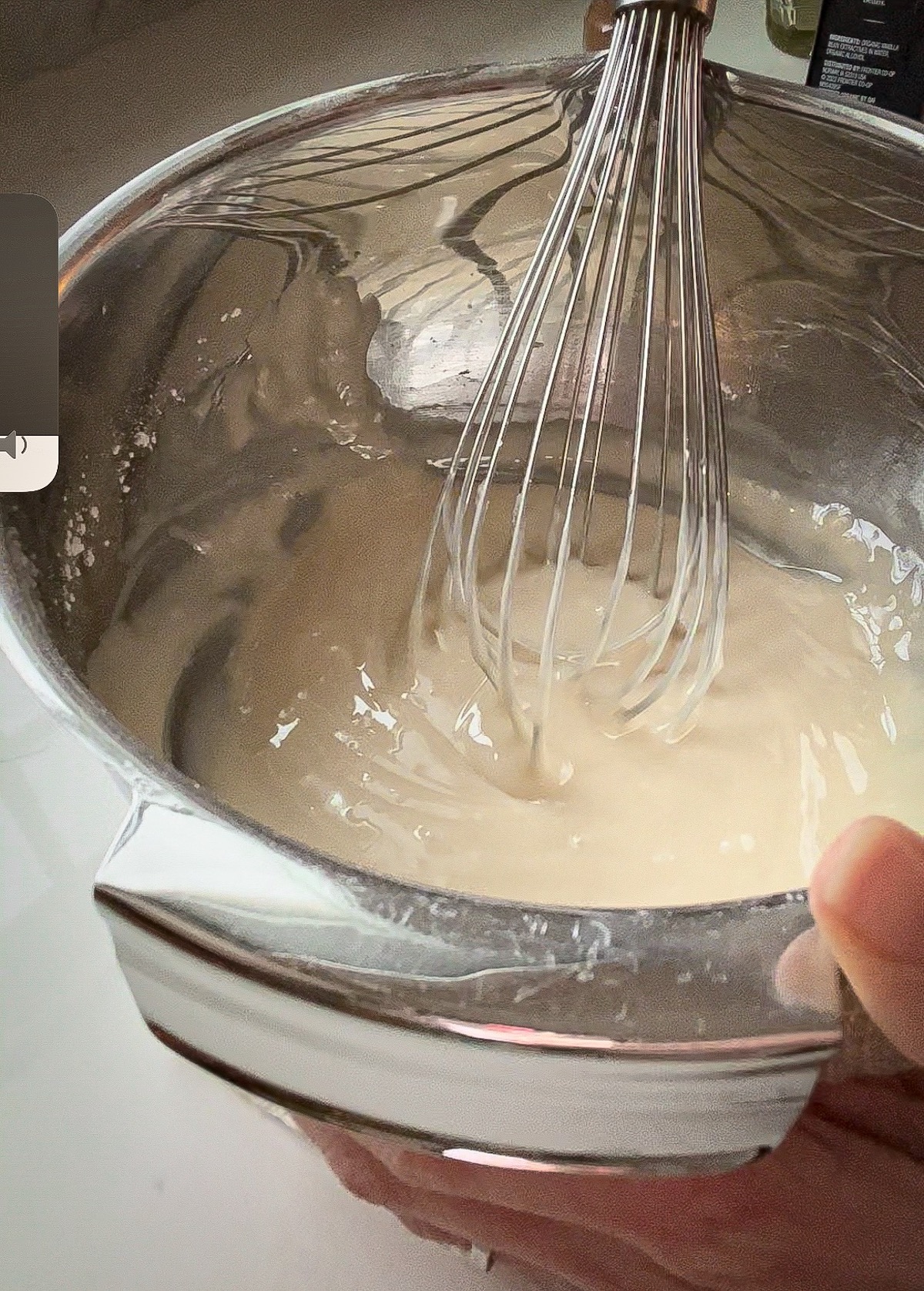 icing for gingerbread cookies in a bowl with a whisk