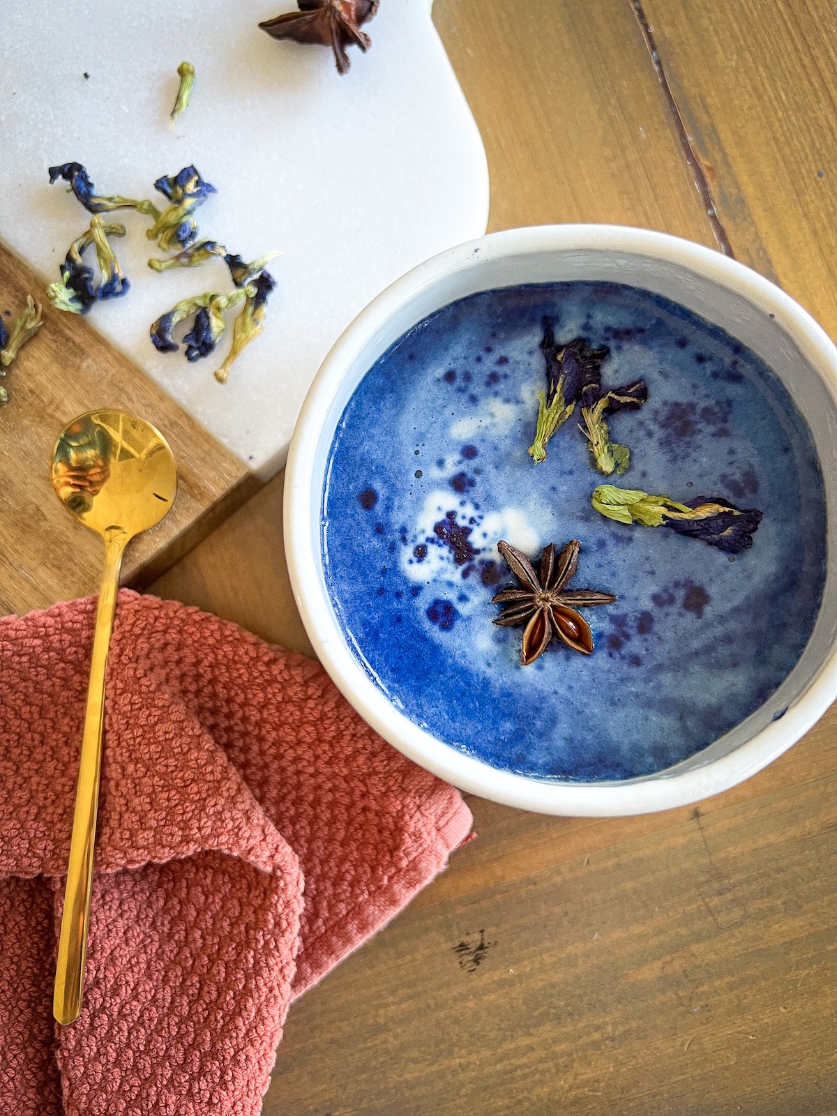 Blue Moon Latte in a large mug garnished with butterfly pea flowers
